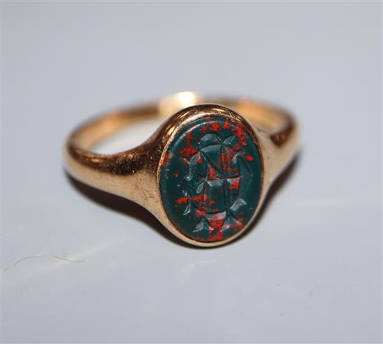 An 18ct gold and oval monogrammed bloodstone set signet ring, size O.